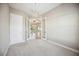 Neutral carpeted bedroom with contemporary lighting and double doors at 10705 Tarflower Dr, Venice, FL 34293