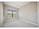 Carpeted bedroom with a large window offering natural light at 10705 Tarflower Dr, Venice, FL 34293