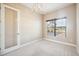 Bedroom with neutral carpet, natural light, and glass paneled door at 10705 Tarflower Dr, Venice, FL 34293
