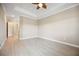 A spacious bedroom featuring wood-style floors, and a tray ceiling at 10705 Tarflower Dr, Venice, FL 34293