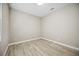 Cozy bedroom with wood look tile flooring and neutral paint at 10705 Tarflower Dr, Venice, FL 34293