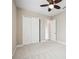 Neutral bedroom with a ceiling fan and closet at 10705 Tarflower Dr, Venice, FL 34293
