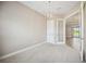 Carpeted bedroom with contemporary lighting adjacent to glass paneled door at 10705 Tarflower Dr, Venice, FL 34293