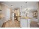 Open concept kitchen with wood flooring, granite counters, and modern stainless steel appliances at 10705 Tarflower Dr, Venice, FL 34293