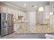 A closer view of the kitchen with stainless steel appliances and granite countertops at 10705 Tarflower Dr, Venice, FL 34293