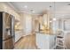 Spacious open concept kitchen with wooden floors, stainless steel appliances, and island seating at 10705 Tarflower Dr, Venice, FL 34293
