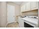 Spacious laundry room with washer, dryer, sink, and ample cabinet storage at 10705 Tarflower Dr, Venice, FL 34293