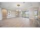 Living room featuring wood floors, a modern chandelier, and access to the lanai at 10705 Tarflower Dr, Venice, FL 34293