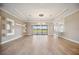 Living room featuring wood floors, a modern chandelier, and access to the lanai at 10705 Tarflower Dr, Venice, FL 34293