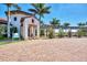 Palm Club exterior featuring inviting entryway, pergola, and landscaped grounds at 10705 Tarflower Dr, Venice, FL 34293