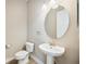 Clean and well-lit powder room with pedestal sink and classic fixtures at 10705 Tarflower Dr, Venice, FL 34293