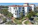 White building with red tile roof and lush landscaping at 11200 Hacienda Del Mar Blvd # 201, Placida, FL 33946