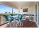 Screened balcony with outdoor kitchen and dining area at 11200 Hacienda Del Mar Blvd # 201, Placida, FL 33946