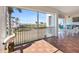 Spacious screened balcony with outdoor seating and partial water view at 11200 Hacienda Del Mar Blvd # 201, Placida, FL 33946