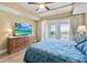 King-size bed, hardwood floors, large TV and balcony view at 11200 Hacienda Del Mar Blvd # 201, Placida, FL 33946