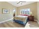 Bedroom with hardwood floors, large windows, and balcony access at 11200 Hacienda Del Mar Blvd # 201, Placida, FL 33946