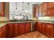 Kitchen boasts granite counters, stainless steel appliances, and wood cabinets at 11200 Hacienda Del Mar Blvd # 201, Placida, FL 33946
