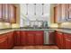 Kitchen with island, granite countertops, and wood cabinets at 11200 Hacienda Del Mar Blvd # 201, Placida, FL 33946