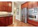 View of kitchen's stainless steel appliances and wood cabinets at 11200 Hacienda Del Mar Blvd # 201, Placida, FL 33946