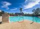 Sparkling community pool with brick deck and building view at 11200 Hacienda Del Mar Blvd # 201, Placida, FL 33946