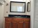 Bathroom with dark wood vanity, granite countertop, and a large mirror at 13100 S Mccall Rd # 110, Port Charlotte, FL 33981