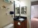 Bathroom with dark wood vanity, granite countertop, and a large mirror at 13100 S Mccall Rd # 110, Port Charlotte, FL 33981