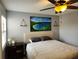 King-size bed in a spacious bedroom with large windows and artwork at 13100 S Mccall Rd # 110, Port Charlotte, FL 33981