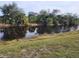 Peaceful view of a canal with lush greenery and palm trees at 13100 S Mccall Rd # 110, Port Charlotte, FL 33981