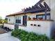 Front view of charming villa with landscaped yard and pergola at 13100 S Mccall Rd # 110, Port Charlotte, FL 33981