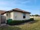 Well-maintained stucco home with a neatly landscaped yard and dark brown roof at 13100 S Mccall Rd # 110, Port Charlotte, FL 33981