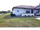 Side view of villa showcasing a private backyard and landscaping at 13100 S Mccall Rd # 110, Port Charlotte, FL 33981