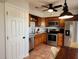 Kitchen with wood cabinets, granite counters and stainless steel appliances at 13100 S Mccall Rd # 110, Port Charlotte, FL 33981