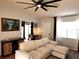 Spacious living room with sectional sofa and wood media console at 13100 S Mccall Rd # 110, Port Charlotte, FL 33981
