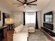 Spacious living area featuring a sectional sofa, fireplace, and ceiling fan at 13100 S Mccall Rd # 110, Port Charlotte, FL 33981