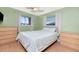 Guest bedroom with light green walls, ceiling fan, and double closets at 139 Rotonda Cir, Rotonda West, FL 33947