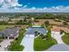 Aerial view of house, pool, and surrounding neighborhood at 142 Island Ct, Rotonda West, FL 33947