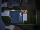 Aerial view of house, pool, and backyard at dusk at 142 Island Ct, Rotonda West, FL 33947