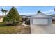 House exterior showcasing a gray color scheme, landscaping, and a walkway at 1471 Deer Creek Dr, Englewood, FL 34223