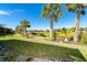 Expansive backyard with pond view and mature palm trees at 1506 Hyssop Loop, North Port, FL 34289