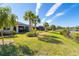 Landscaped backyard showcasing a beautiful pond view and homes along the water at 1506 Hyssop Loop, North Port, FL 34289