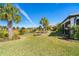 Spacious backyard with lush landscaping and water views at 1506 Hyssop Loop, North Port, FL 34289