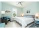 Bright bedroom featuring a king-size bed and sitting area at 1506 Hyssop Loop, North Port, FL 34289