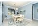 Light and airy dining room with a white table and chairs, and a large window at 1506 Hyssop Loop, North Port, FL 34289