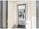 Front entry with screen door and view into the living room at 1506 Hyssop Loop, North Port, FL 34289