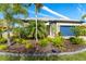 Landscaped front yard with tropical plants and a one-story house at 1506 Hyssop Loop, North Port, FL 34289
