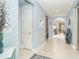 Bright hallway with light blue walls and tile flooring at 1506 Hyssop Loop, North Port, FL 34289