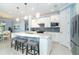 Modern kitchen with white cabinets, a large island, and stainless steel appliances at 1506 Hyssop Loop, North Port, FL 34289