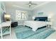 Spacious main bedroom with a comfy bed, ceiling fan, and plenty of natural light at 1506 Hyssop Loop, North Port, FL 34289