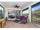 Relaxing screened lanai with seating area, brick flooring, and view of backyard at 1506 Hyssop Loop, North Port, FL 34289