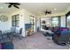 Spacious screened porch with seating area, dining table and backyard view at 1506 Hyssop Loop, North Port, FL 34289